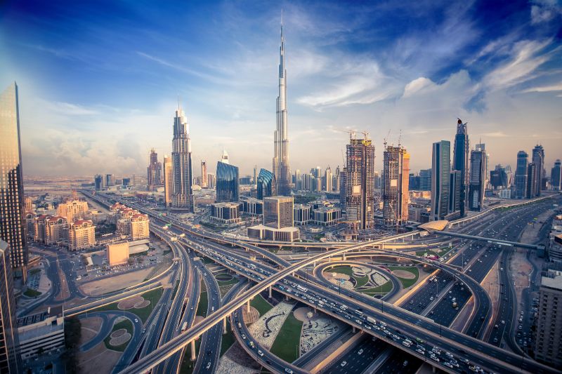 dubai-visa-online-skyline-with-beautiful-city-close-to-its-busiest-highway-on-traffic-78032294-min