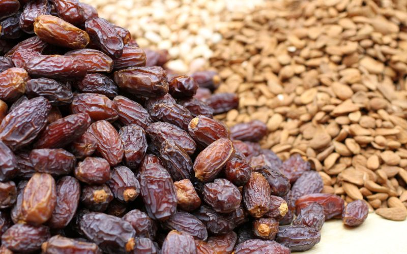 dubai-tourist-visa-big-dried-dates-raw-almonds-and-cashews-lying-on-a-large-counter-at-the-market-in-deira-dubai-185491034-min